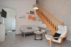 a living room with a staircase and a couch at Pause campagne in Fagnières