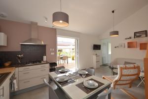 a kitchen and living room with a table and chairs at Pause campagne in Fagnières +13 photos