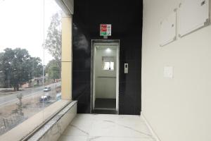 a hallway with a door in a building at FabHotel Rudra in Dehradun +27 photos