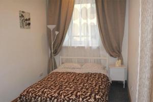 a bedroom with a bed and a window with curtains at pokojówka,WiFi,parking P in Poznań