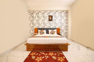 a bedroom with a bed with a floral wallpaper at FabHotel Rudra in Dehradun