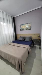 a bedroom with a large bed and a window at pokojówka,WiFi,parking P in Poznań