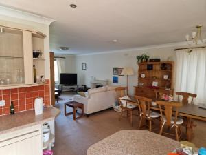 a kitchen and living room with a couch and a table at Brandane in Brodick
