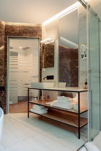 a bathroom with a sink and a mirror at GRANDI 32 Boutique Residence in Segrate +38 photos