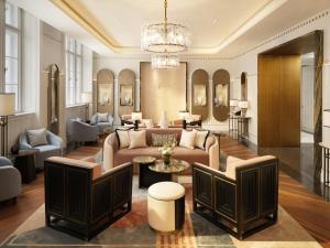 a living room with a couch and a table at Mandarin Oriental, Vienna in Vienna