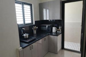 a kitchen with a counter top with a microwave at Orin Suites Gachibowli in Hyderabad