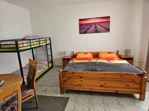 a bedroom with a bed and two bunk beds at BiRo-Apartments in Zalavár