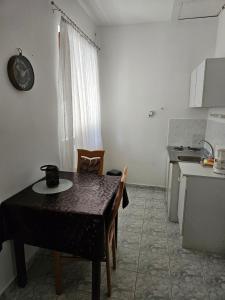 a table and chairs in a kitchen with a table and a table at BiRo-Apartments in Zalavár