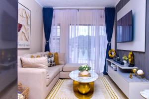 a living room with a couch and a table at Kunashe Apartments in Harare