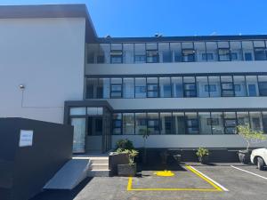 a building with a parking lot in front of it at Marine Hotel in East London