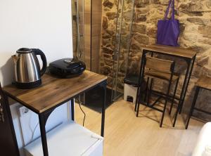 a room with a table with a tea kettle on it at Pensión A Lubre in Fisterra