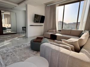 a living room with a couch and a tv at Batroun Staycation in Batroûn