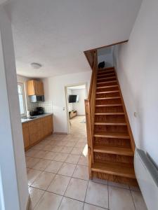 a stairway in a kitchen with a staircase in a house at Wittower Heide 40-3 in Glowe