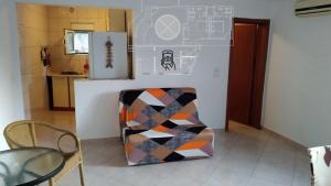 a living room with a chair and a refrigerator at Villa Lavanda in Sutomore