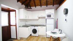 a kitchen with a washer and dryer and a table at Casita Las Lajas in El Paso