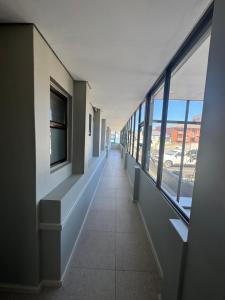 a hallway of a building with windows and a hallway sidx sidx at Marine Hotel in East London
