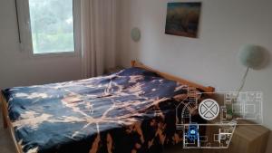 a bedroom with a bed with a blue comforter at Villa Lavanda in Sutomore