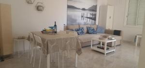a living room with a table and a couch at Sea Heart Villa Beachfront in Pyla