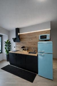 a kitchen with a white refrigerator and a sink at Apartamento exclusivo Muralla de Lugo 1.1 in Lugo