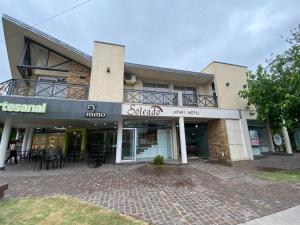 a building with a patio in front of it at Soleado Apart Hotel in San Rafael