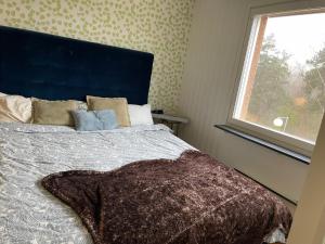 a bedroom with a bed with a large window at Big Room in shared apartment in Kungälv