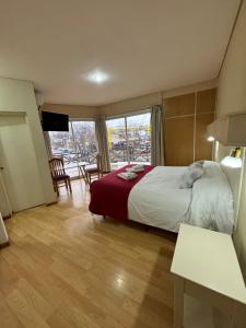 a hotel room with a bed and a balcony at Soleado Apart Hotel in San Rafael +61 photos