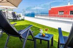 a patio with two chairs and a table with a drink at URBANSEA Atlanta in Las Palmas de Gran Canaria
