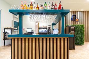 a blue bar with glasses on top of it at URBANSEA Atlanta in Las Palmas de Gran Canaria