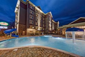 a swimming pool at a hotel at night at Black Fox Lodge Pigeon Forge, Tapestry Collection by Hilton in Pigeon Forge +68 photos