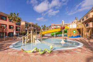 a pool with a water park with a slide at BLUESEA Aloe Corralejo in Corralejo