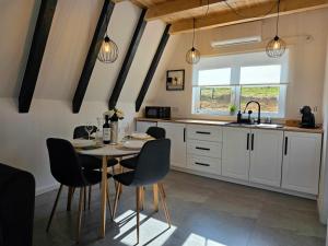 a kitchen with a table and chairs and a sink at REIA A-frame in Gura Râului