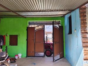 a garage with an open door with a fire truck in it at Balendra Kumar in Tarahti