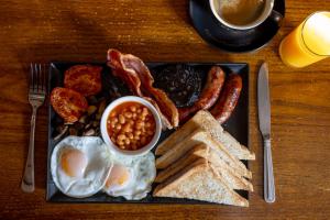 a plate of breakfast food with eggs bacon beans and toast at The bucks head in Church Stretton