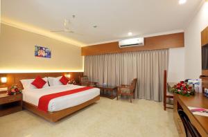 a large hotel room with a bed and a desk at Hotel Indraprastha Kozhencherry in Kozhancheri +33 photos