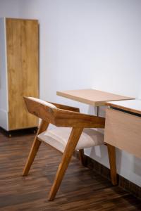 a wooden table and a chair at a desk at Dreamscape Banjara Hills in Hyderabad