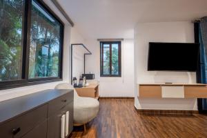 a living room with a flat screen tv on a wall at Dreamscape Banjara Hills in Hyderabad