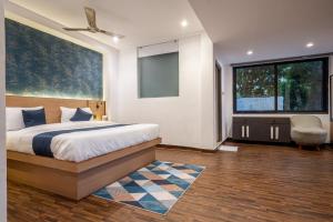 a bedroom with a bed and a large window at Dreamscape Banjara Hills in Hyderabad