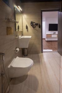 a bathroom with a toilet and a sink at Dreamscape Banjara Hills in Hyderabad +18 photos