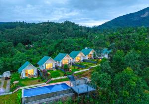 an aerial view of a house with a swimming pool at Gardenia Pool Resort Kanthalloor by VOYE HOMES Mountain View Stay Near Bhramaram view Point in Kanthalloor