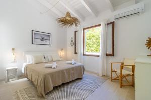 a bedroom with a bed with two towels on it at Villa Linda by 3VILLAS in Son Parc