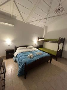a bedroom with a bed with two towels on it at Capo Scalambri in Santa Croce Camerina
