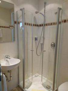 a bathroom with a shower and a sink at Hotel Pfeffermühle in Borchen