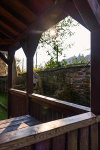 an outside view of a wooden porch with a stone wall at The bucks head in Church Stretton