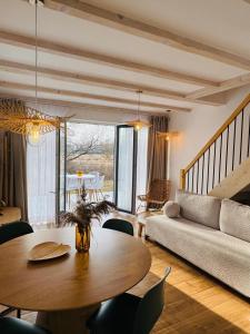 a living room with a table and a couch at Białe Tarasy in Rogowo