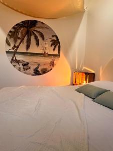 a bedroom with a white bed and a round mirror at Logement Pirate themed suite with parking in Vesoul