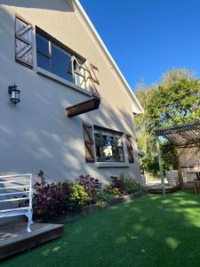 a house with a yard with green grass at Loft on Honey in Sunridge Park
