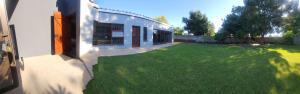 an image of a yard with a building at McCrae's Garden Suite in Malmesbury