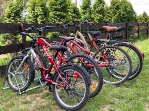 a group of bikes parked next to a fence at Makosieje Resort-15m od brzegu,widok na jezioro,wi-fi in Makosieje