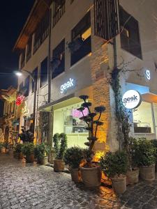 a store with potted plants on the side of a building at Nisyan Konağı 1921 in Şahinbey