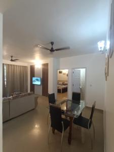 a living room with a glass table and a couch at 1 bhk apartment ruby residency in Canacona